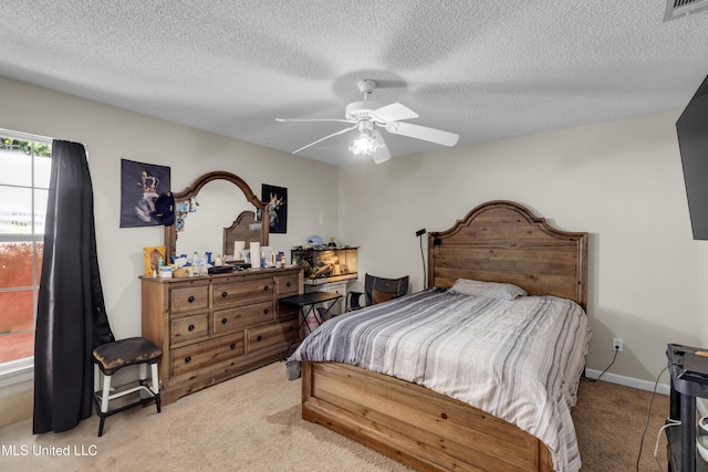 3005 Robalo Dr, Gautier, MS 39553 - bedroom featuring light carpet, a textured ceiling, and a ceiling fan