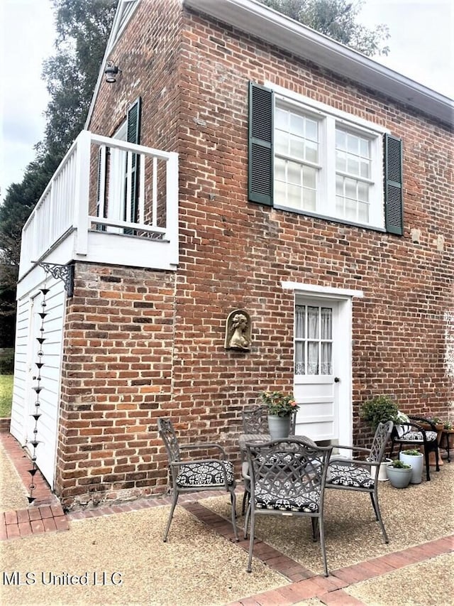 707 State St Unit 705, Natchez, MS 39120 - view of property exterior featuring brick siding, a balcony, and a patio