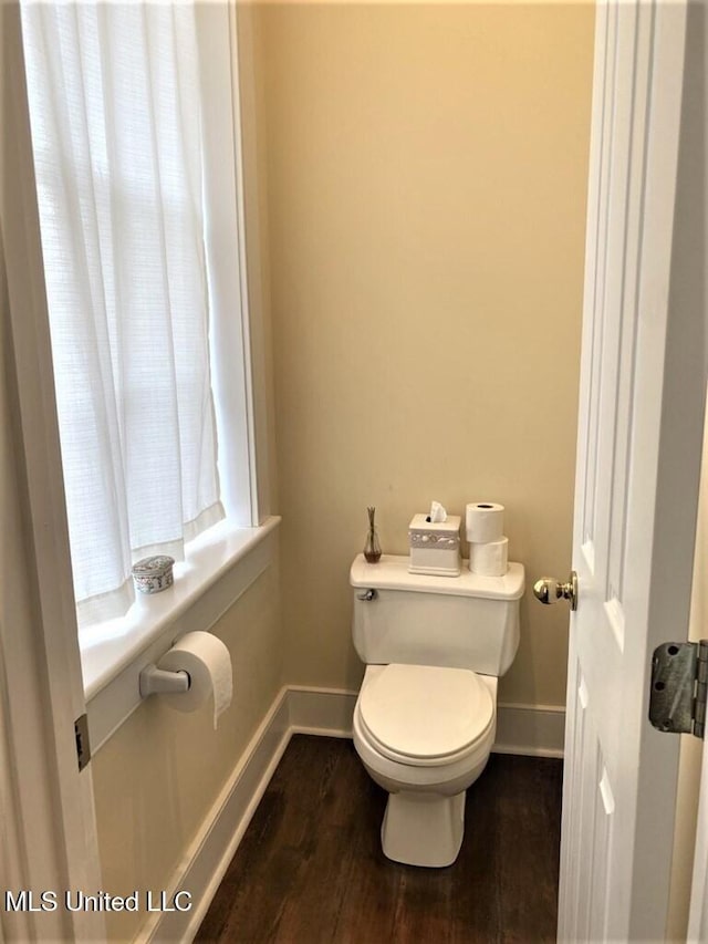 707 State St Unit 705, Natchez, MS 39120 - bathroom featuring baseboards, toilet, and wood finished floors