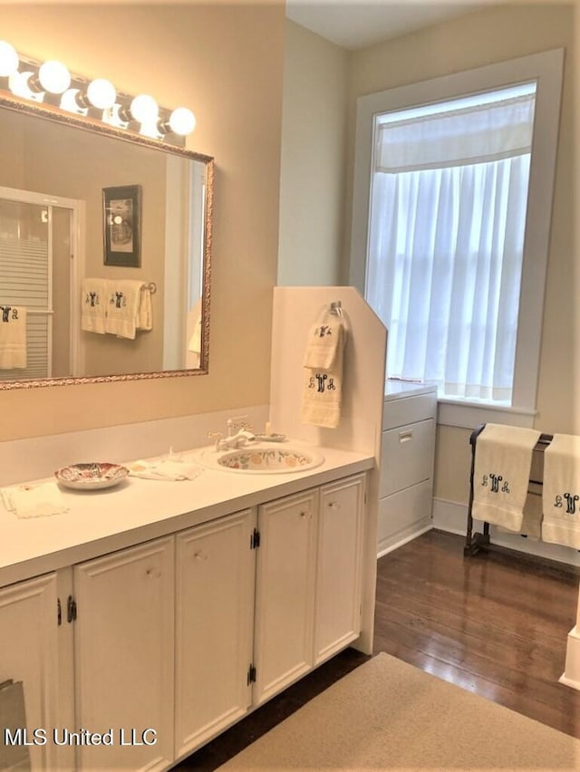 707 State St Unit 705, Natchez, MS 39120 - full bathroom with wood finished floors, vanity, an enclosed shower, and baseboards