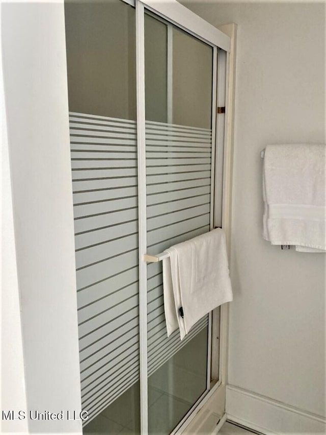 707 State St Unit 705, Natchez, MS 39120 - bathroom with baseboards and a stall shower