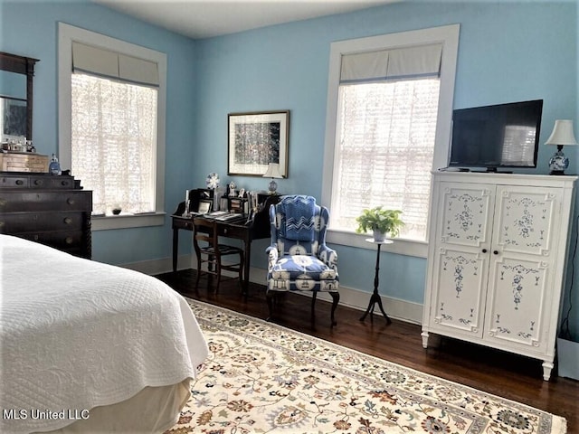 707 State St Unit 705, Natchez, MS 39120 - bedroom with multiple windows, wood finished floors, and baseboards