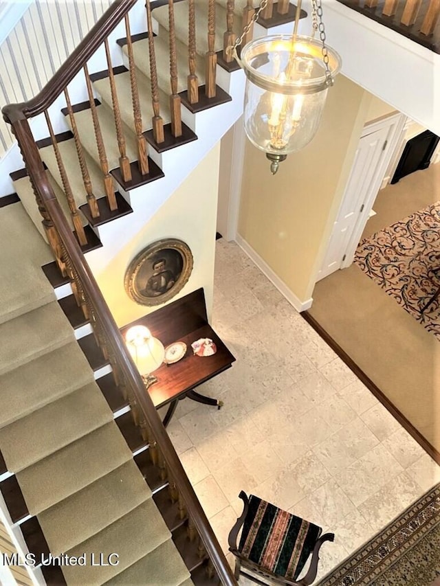 707 State St Unit 705, Natchez, MS 39120 - stairway with a chandelier and baseboards