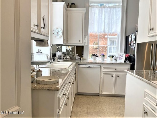 707 State St Unit 705, Natchez, MS 39120 - kitchen with white dishwasher, a sink, white cabinetry, light tile patterned flooring, and freestanding refrigerator