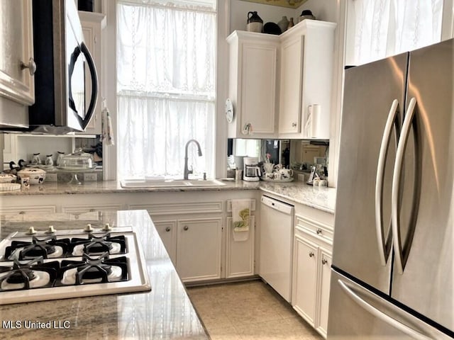 707 State St Unit 705, Natchez, MS 39120 - kitchen featuring appliances with stainless steel finishes, a sink, white cabinetry, light stone counters, and light tile patterned floors