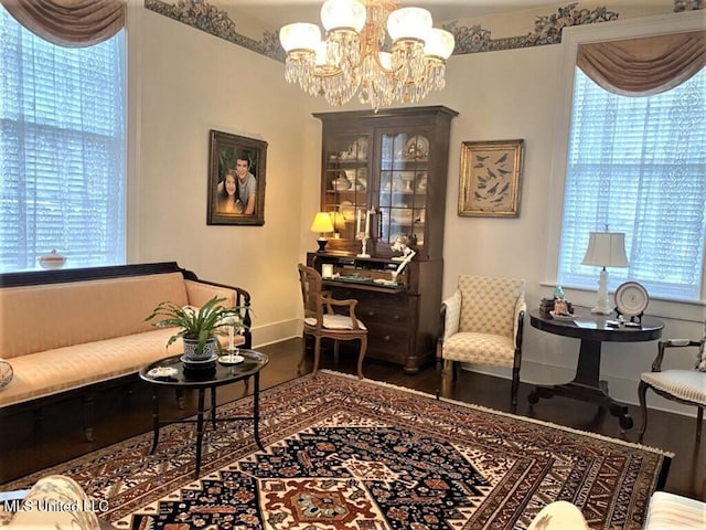 707 State St Unit 705, Natchez, MS 39120 - living area featuring a chandelier, wood finished floors, and baseboards