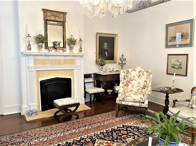 707 State St Unit 705, Natchez, MS 39120 - living area featuring wood finished floors, baseboards, a chandelier, and a fireplace with raised hearth