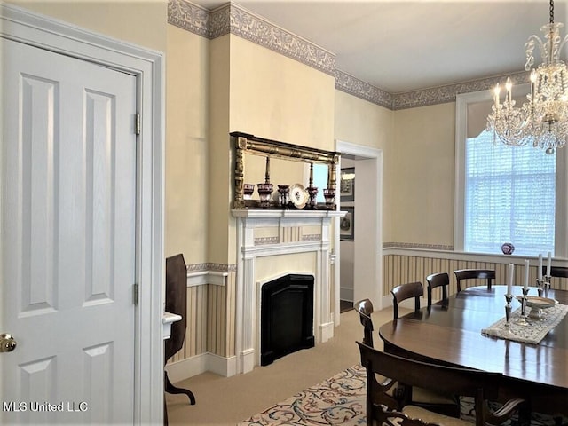 707 State St Unit 705, Natchez, MS 39120 - carpeted dining room featuring a chandelier, a wainscoted wall, and a fireplace