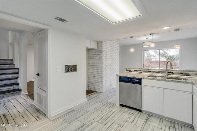 kitchen with pendant lighting, sink, stainless steel dishwasher, and white cabinets