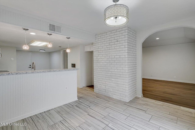 interior space featuring sink and brick wall