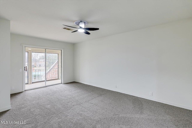 carpeted spare room featuring ceiling fan