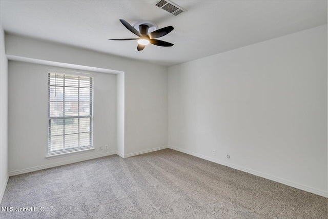 carpeted spare room with ceiling fan