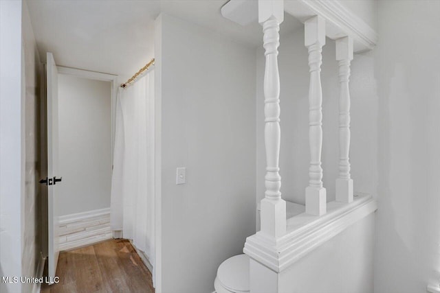 bathroom featuring hardwood / wood-style flooring and toilet