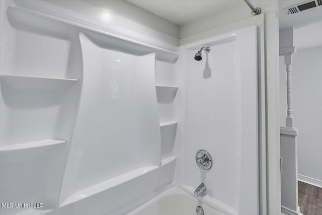 bathroom featuring shower / bathtub combination and wood-type flooring