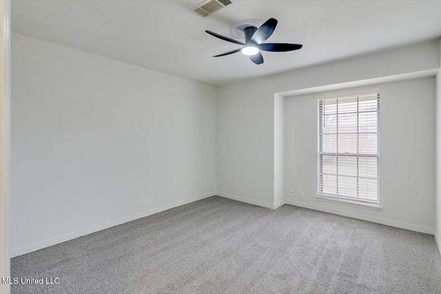 carpeted spare room with ceiling fan