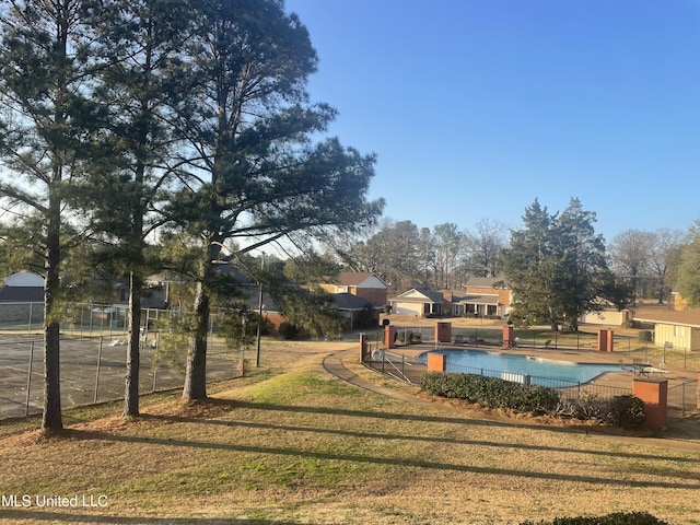 view of swimming pool with a lawn