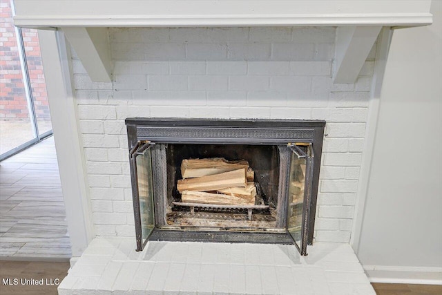 room details with hardwood / wood-style flooring and a brick fireplace