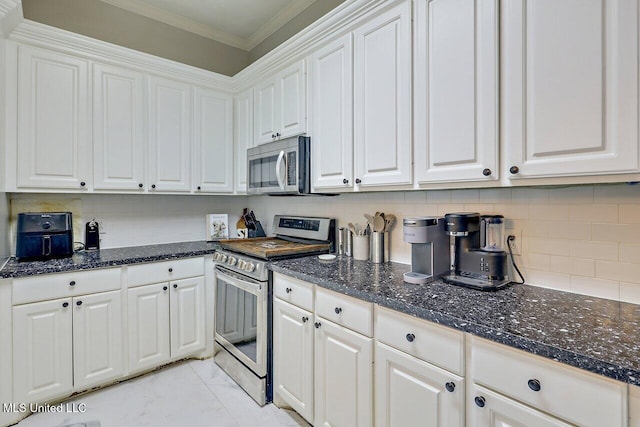 30 Charleston Cir, Brandon, MS 39047 - kitchen with stainless steel appliances, ornamental molding, white cabinets, decorative backsplash, and dark stone counters