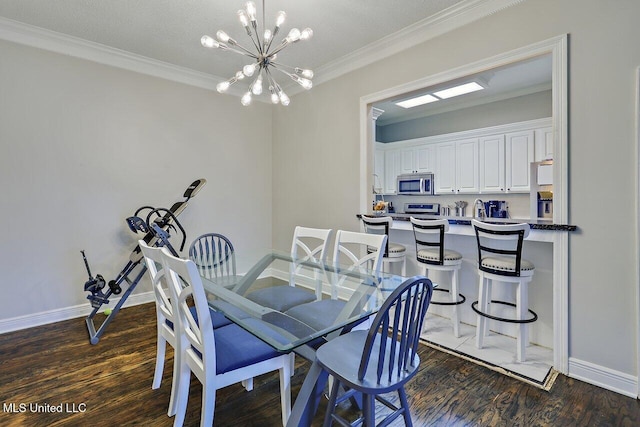 30 Charleston Cir, Brandon, MS 39047 - dining area with wood finished floors, a chandelier, and crown molding