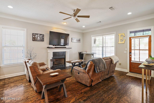 30 Charleston Cir, Brandon, MS 39047 - living room with ceiling fan, dark wood-style floors, a tiled fireplace, ornamental molding, and recessed lighting