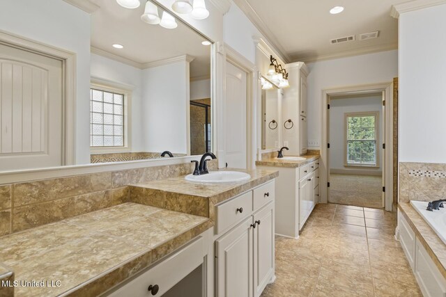 130 Camden Xing, Madison, MS 39110 - full bath featuring crown molding, tile patterned floors, two vanities, a garden tub, and recessed lighting