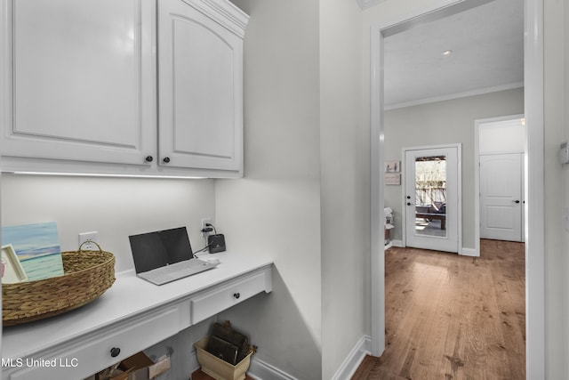 interior space featuring crown molding and hardwood / wood-style flooring