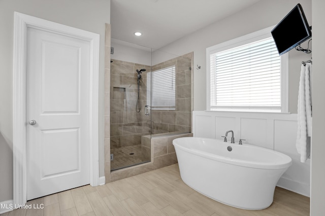 bathroom featuring shower with separate bathtub