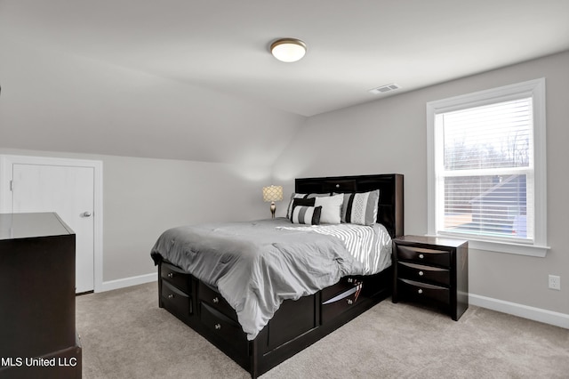 carpeted bedroom with vaulted ceiling