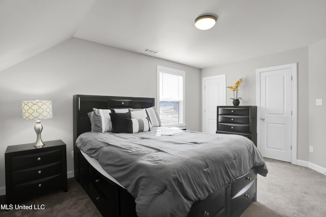 bedroom with lofted ceiling and dark carpet