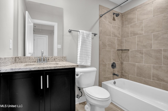 full bathroom with tiled shower / bath combo, vanity, and toilet