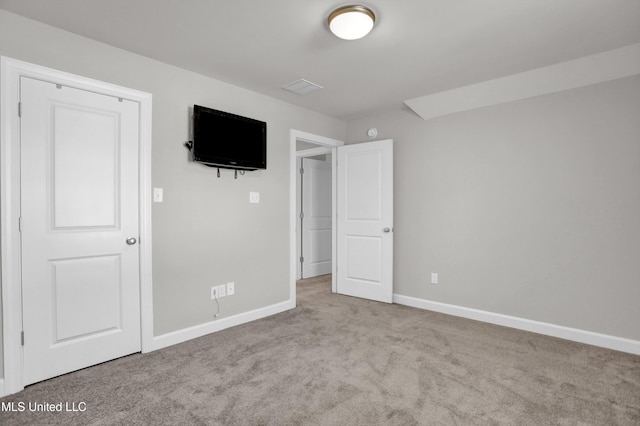 unfurnished bedroom featuring light carpet