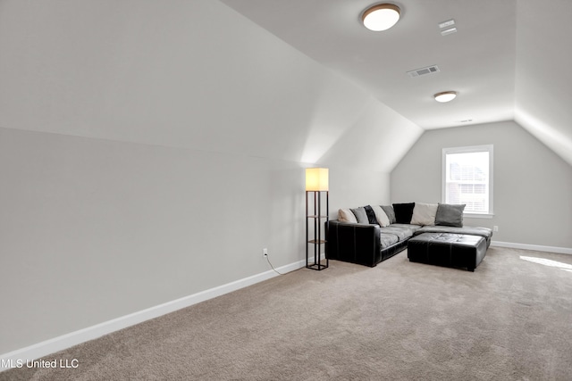 carpeted living room with vaulted ceiling