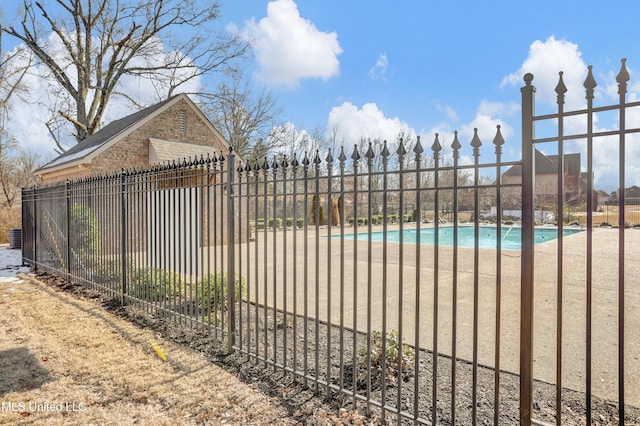 view of gate featuring a community pool