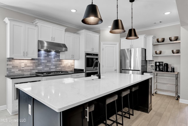 kitchen with stainless steel appliances, white cabinets, and decorative light fixtures