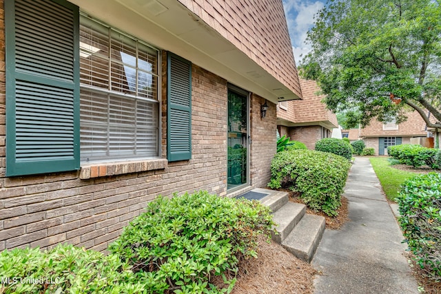property entrance featuring brick siding