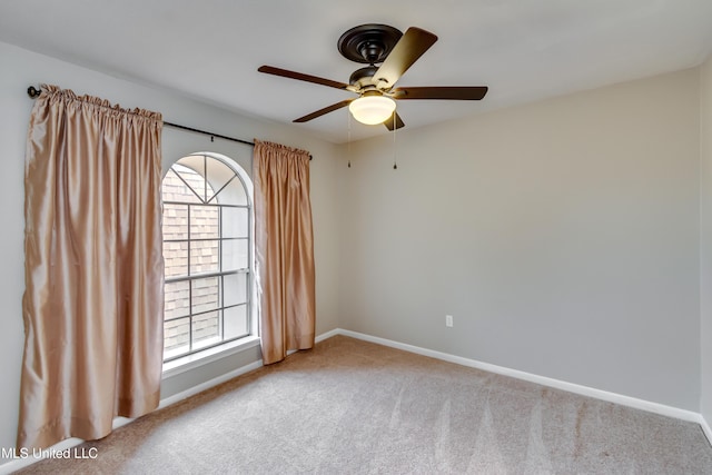 unfurnished room featuring carpet, baseboards, and a ceiling fan