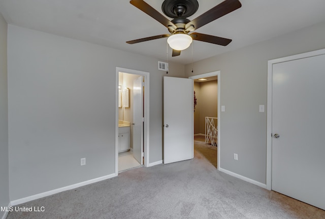 unfurnished bedroom featuring carpet flooring, baseboards, ensuite bathroom, and ceiling fan
