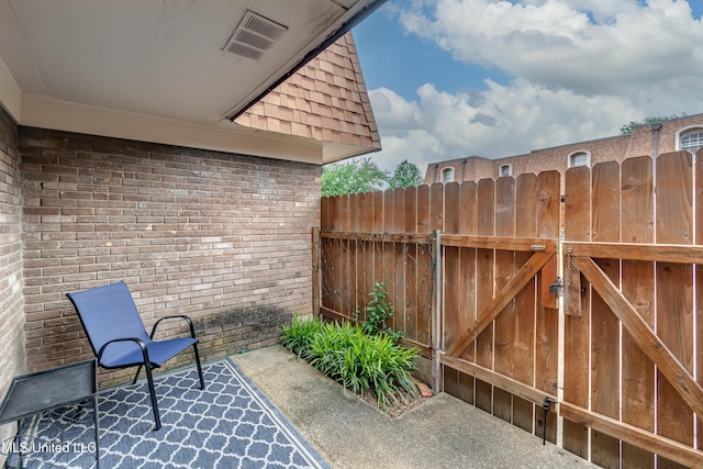 view of patio / terrace featuring fence and a gate