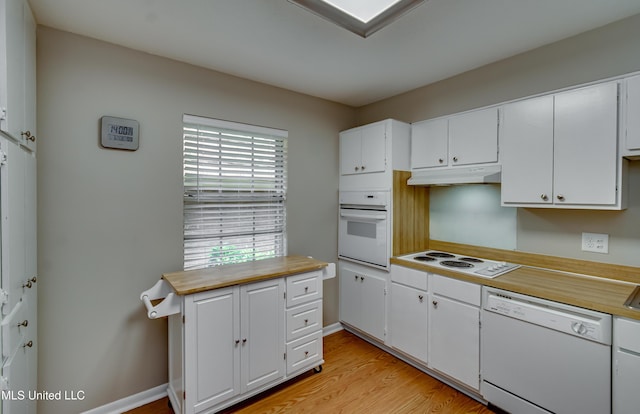 kitchen featuring white appliances, light wood-type flooring, light countertops, and white cabinets