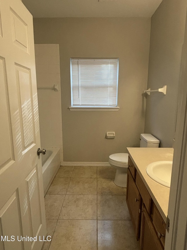 bathroom with tile patterned floors, toilet, vanity, and baseboards