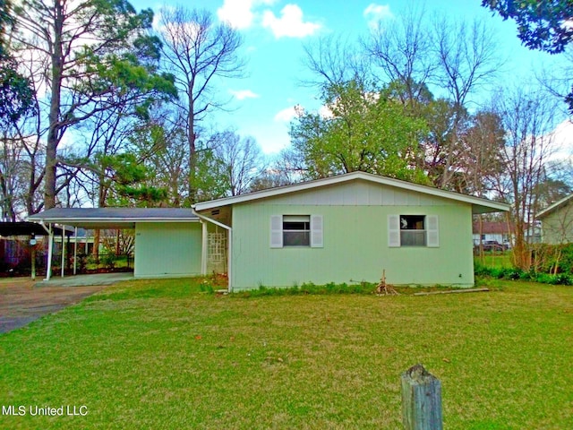 view of front facade with a front yard and a carport