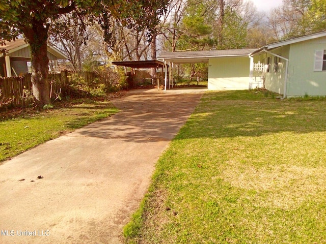 ranch-style house with a front yard and a carport