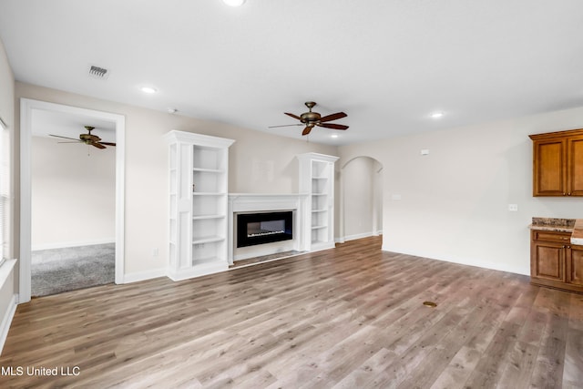 14864 Audubon Lake Blvd, Gulfport, MS 39503 - unfurnished living room with a ceiling fan, light wood-style flooring, arched walkways, and recessed lighting