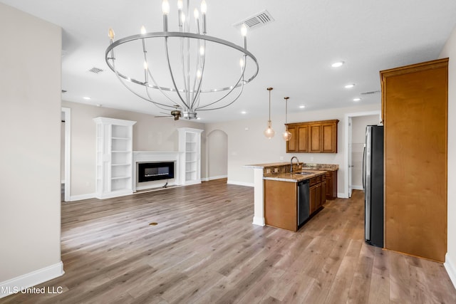 14864 Audubon Lake Blvd, Gulfport, MS 39503 - kitchen with stainless steel appliances, brown cabinetry, open floor plan, recessed lighting, and a chandelier