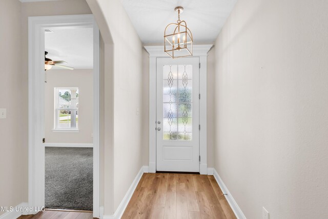 14864 Audubon Lake Blvd, Gulfport, MS 39503 - doorway featuring a chandelier, light wood-style flooring, and ceiling fan