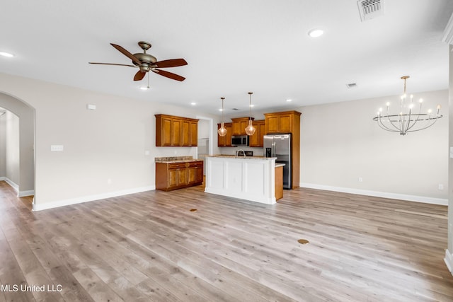14864 Audubon Lake Blvd, Gulfport, MS 39503 - unfurnished living room with arched walkways, a ceiling fan, recessed lighting, light wood-style flooring, and a chandelier
