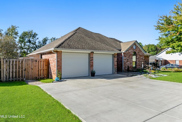 view of front of house with a front yard and a garage