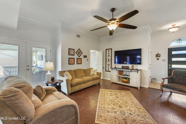 living room featuring ceiling fan, a wealth of natural light, and dark hardwood / wood-style flooring