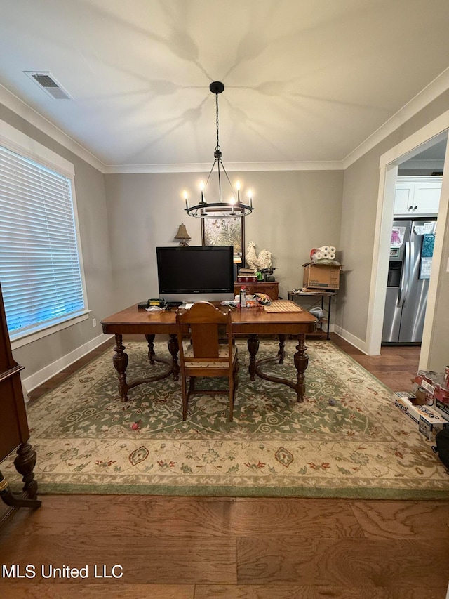 office with crown molding and an inviting chandelier