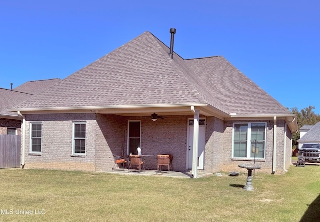 rear view of property featuring a patio, a yard, and ceiling fan